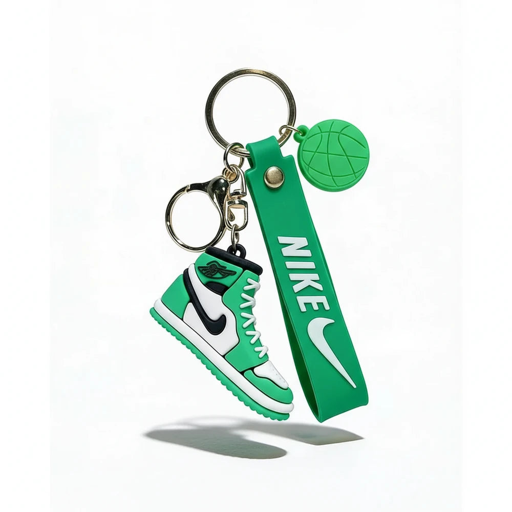 Green Nike keychain with shoe and strap design on a white background