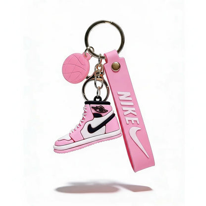 Pink keychain with Nike logo and shoe design on a white background
