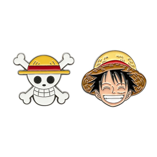 Two enamel pins featuring a skull design and a character with a straw hat on a white background.