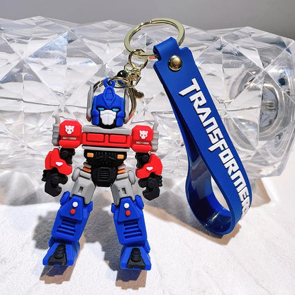 Transformers keychain with blue strap on a textured surface
