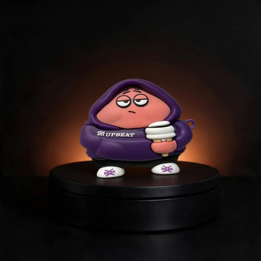 A stylized collectible figure of a pink character Patrick from spongebob case for airpods and buds wearing a purple hoodie with 'UPBEAT' printed on the chest, standing on a black circular platform against a dark background with warm light glow.