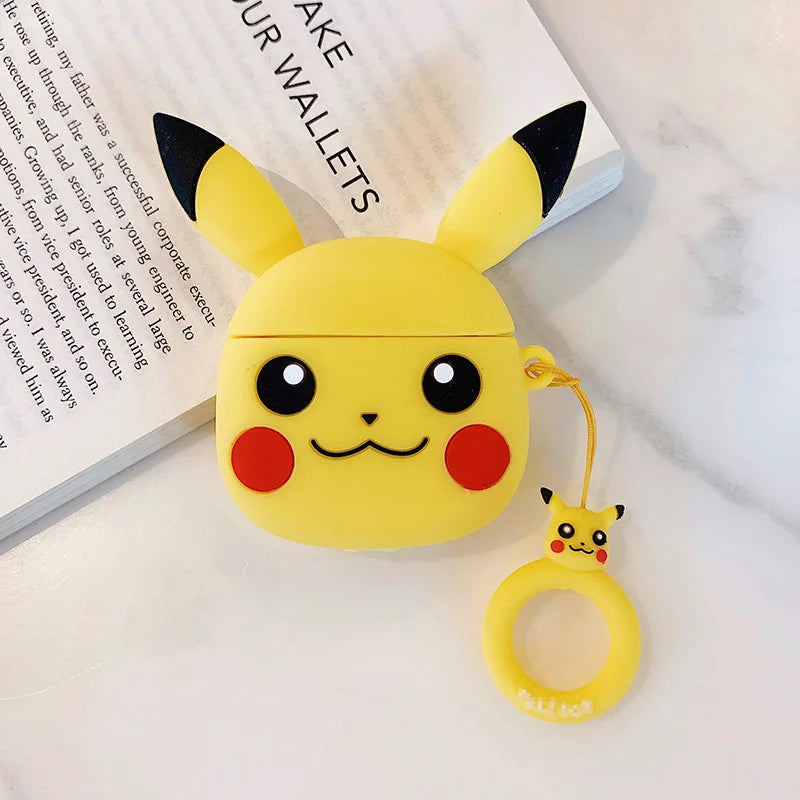 Yellow Pikachu-shaped air pod case with a small keychain on a white surface.