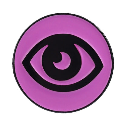 A circular pink and black eye emblem or patch on a plain white background.
