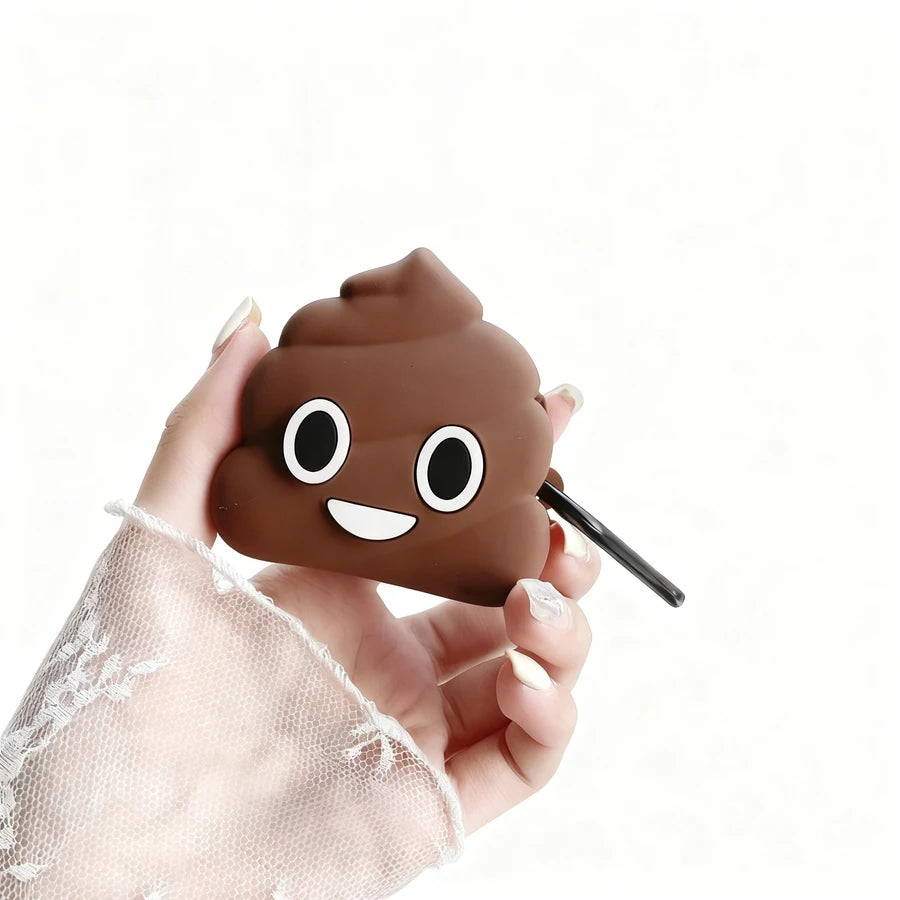 Hand holding a brown poop emoji-shaped air pod case on a white background