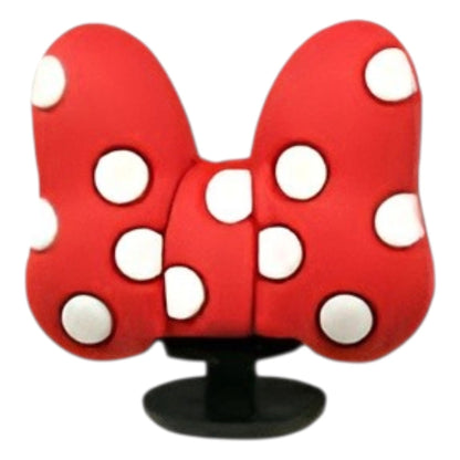 Red butterfly-shaped object with white spots on a white background
