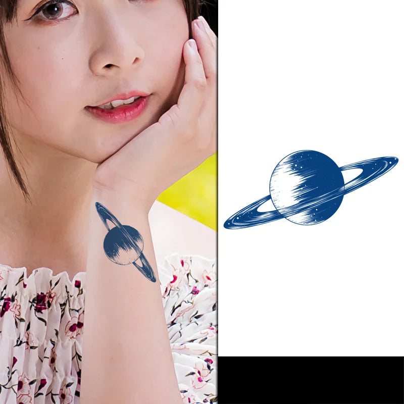 Close-up of a person with a planet-shaped tattoo on their arm