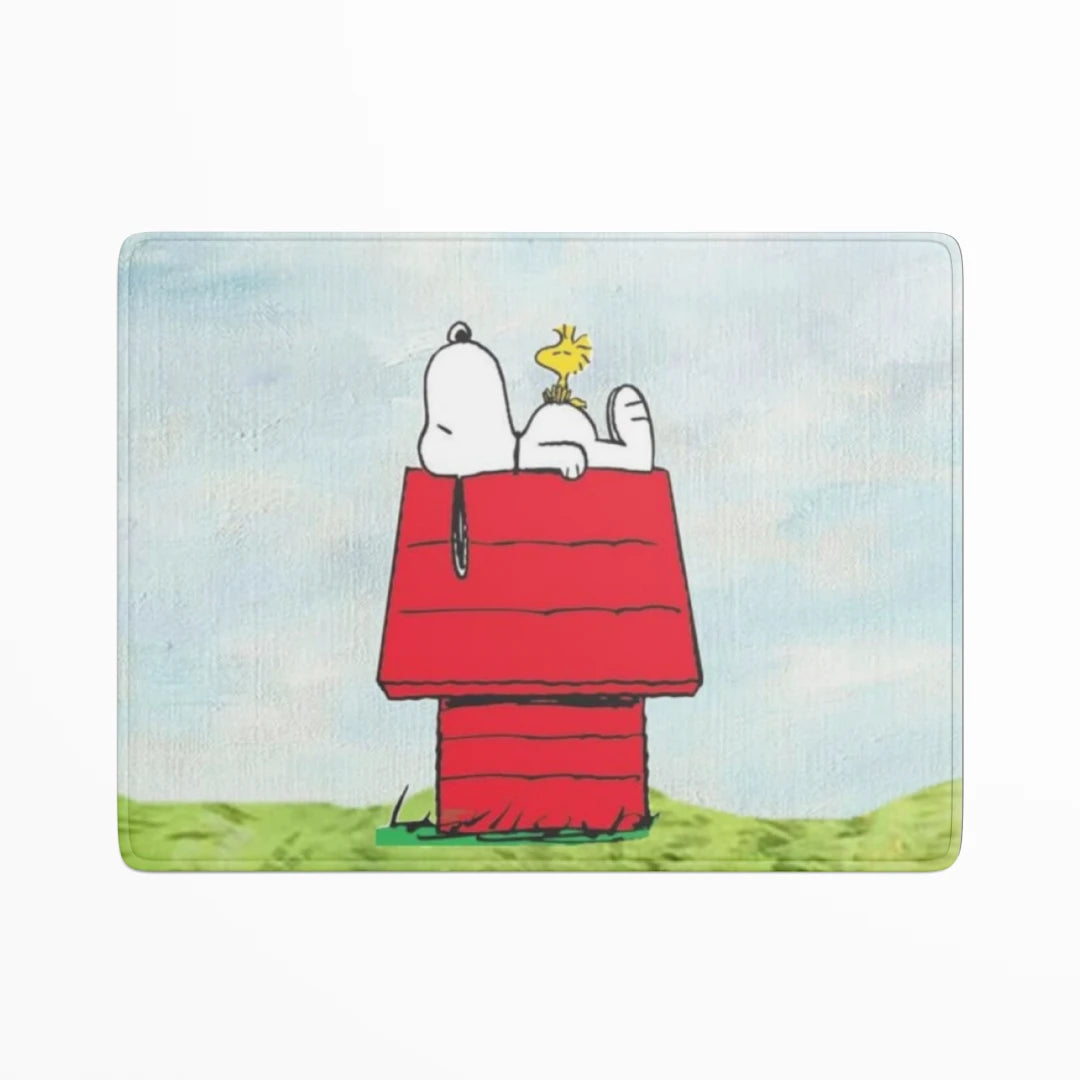 Snoopy and Woodstock on a red doghouse with a blue sky background