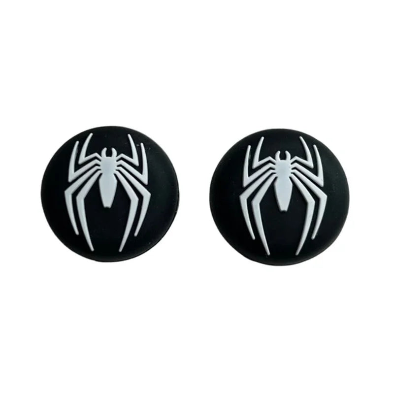 Black earrings with white spider design on a white background
