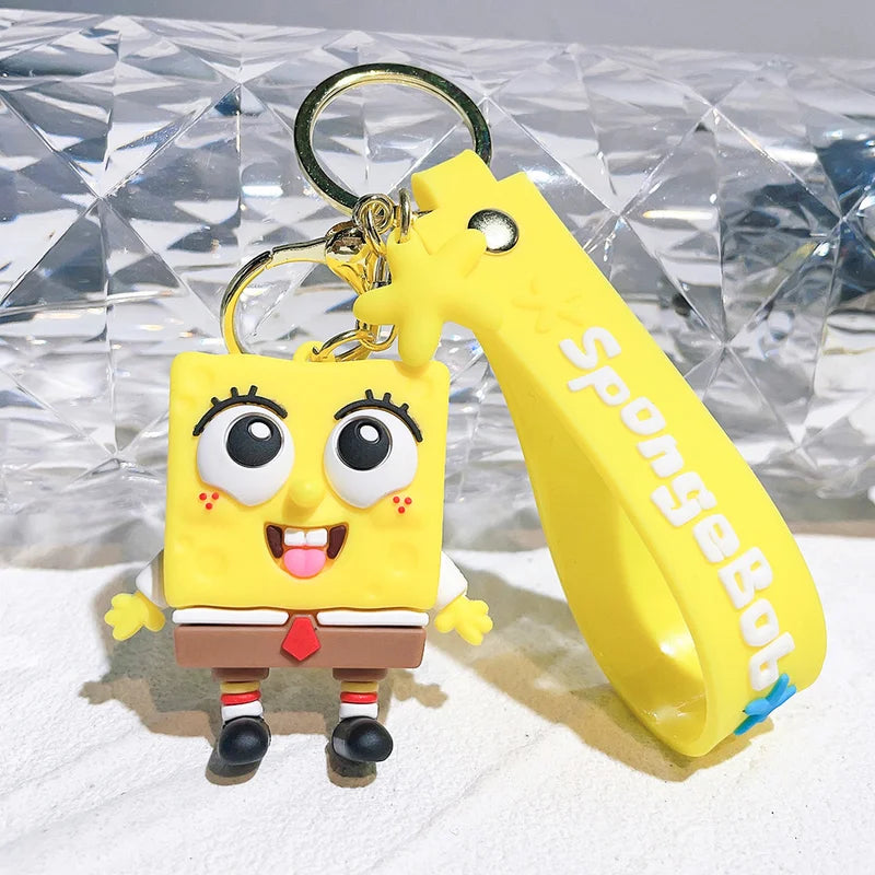 SpongeBob keychain with a yellow tool on a textured surface