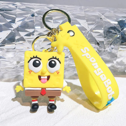 SpongeBob keychain with a yellow tool on a textured surface