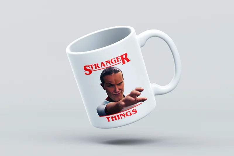 Mug with 'Stranger Things' design featuring a character holding a gun on a light gray background