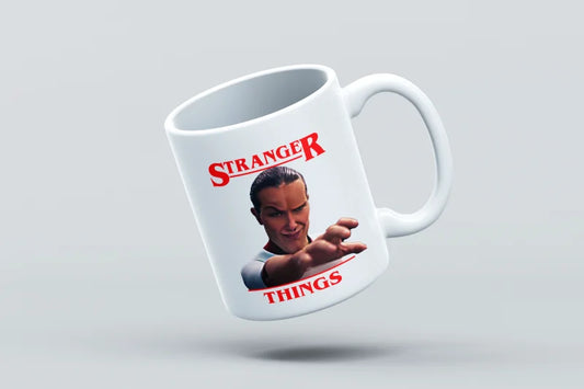 Mug with 'Stranger Things' design featuring a character holding a gun on a light gray background