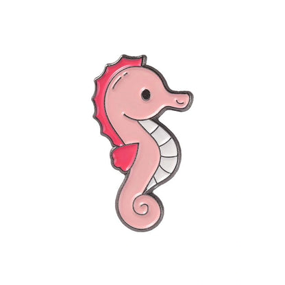 Pink seahorse-shaped enamel pin on a white background