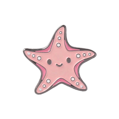 A pink starfish-shaped enamel pin with a cute smiling face, outlined in silver metal and decorated with small white dots, shown on a plain white background.