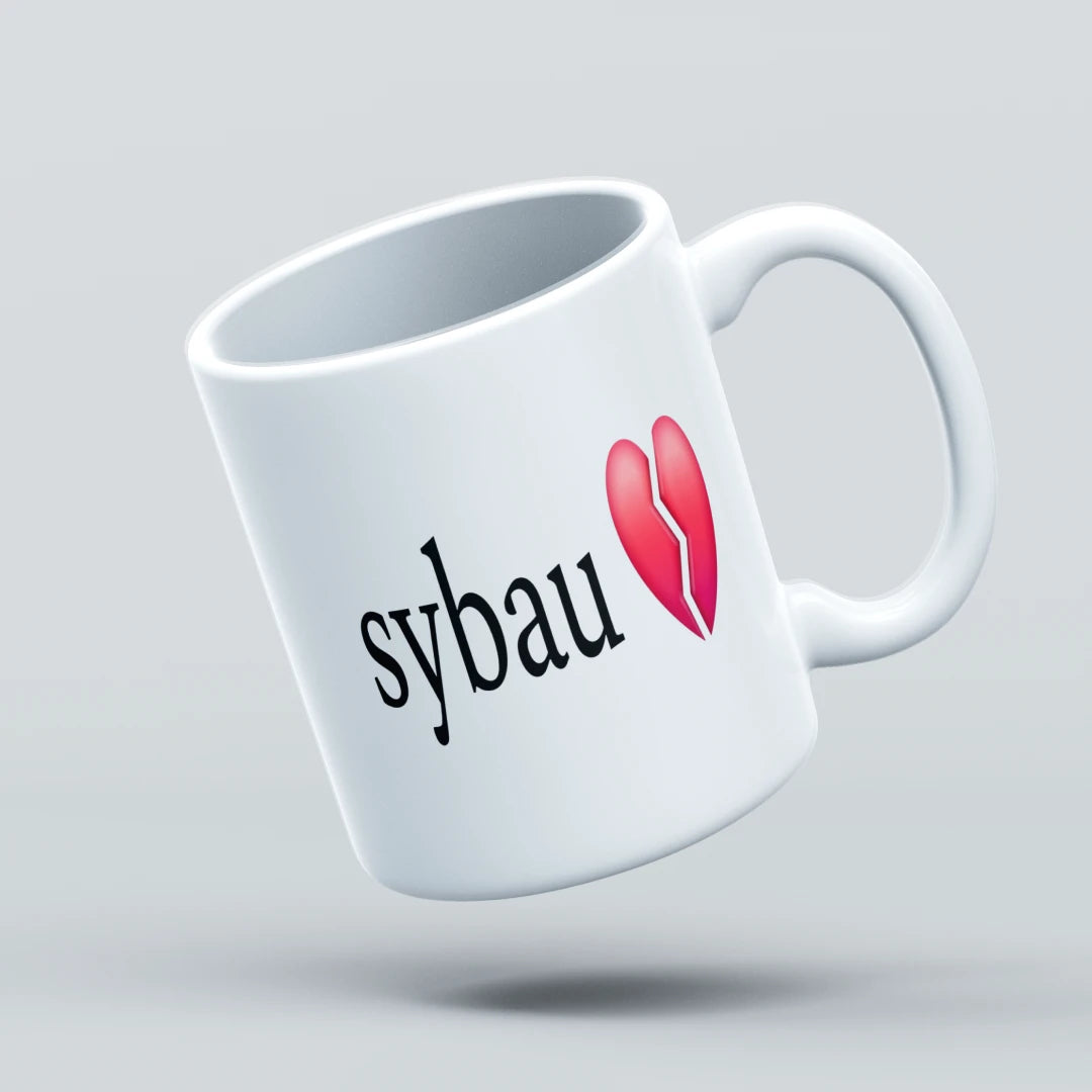 White mug with 'sybau' text and red heart design on a light gray background