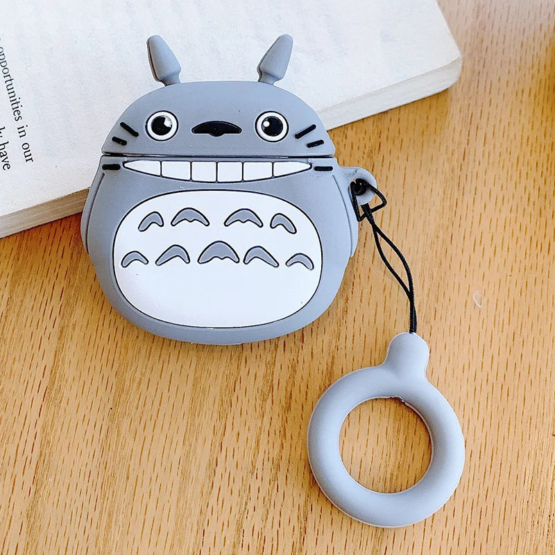 Silicone case with character design and keychain on a wooden surface