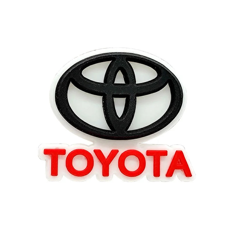 Black Toyota logo croc charm with red text on a white background