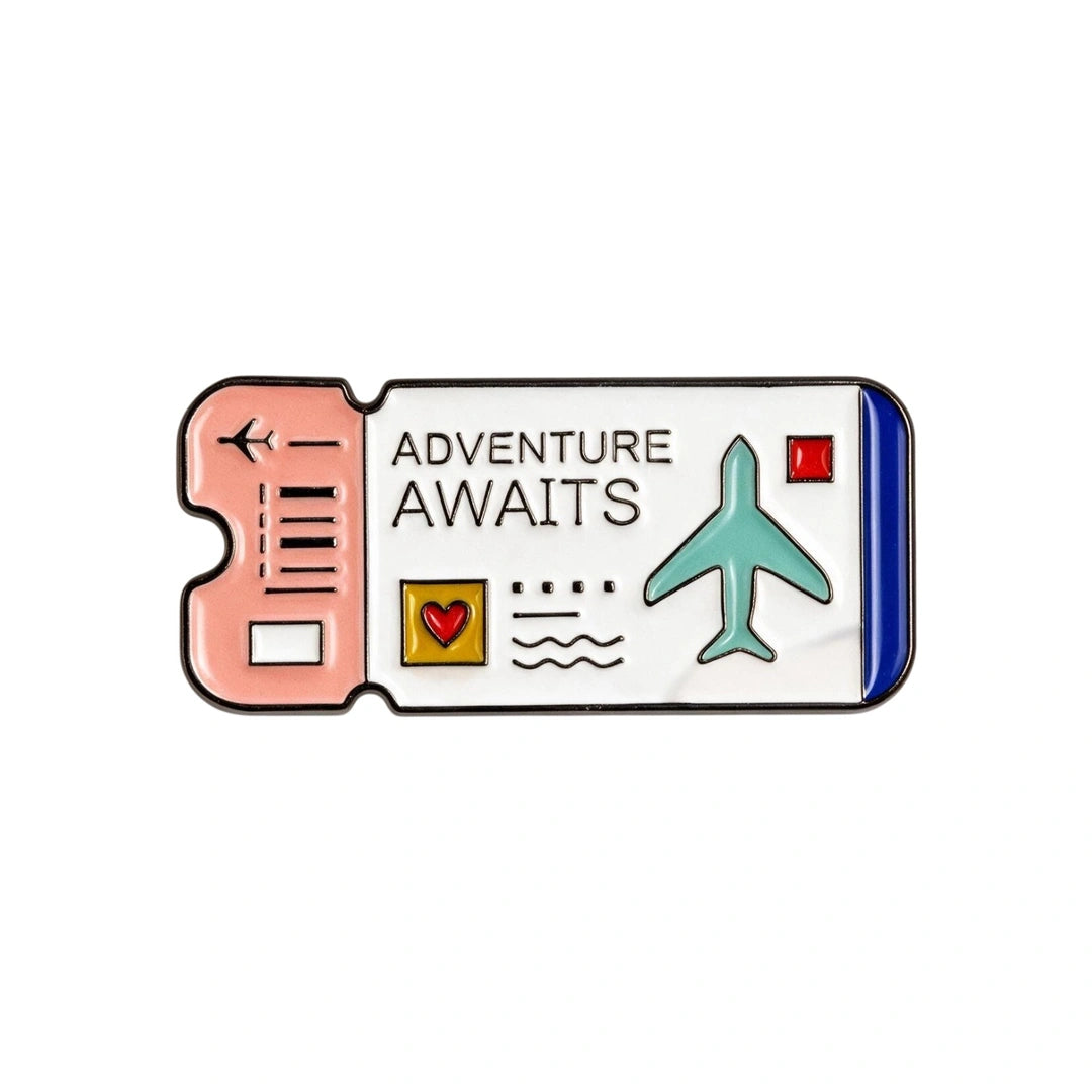A travel ticket-shaped enamel phone sticker with the words 'ADVENTURE AWAITS' on a white panel, featuring a peach-pink left section, a blue right edge, a teal airplane, and small decorative icons.