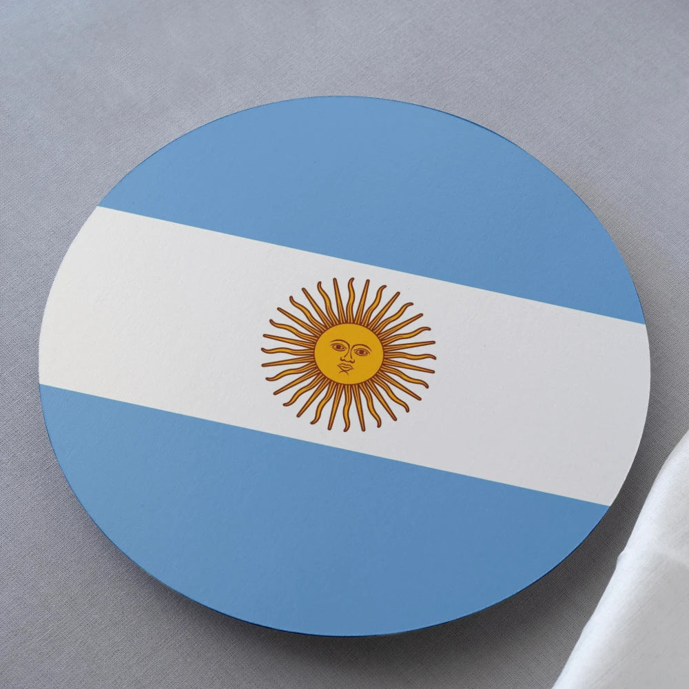 Round coaster with the Argentine flag design on a gray surface