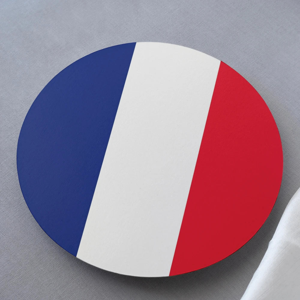 Round coaster with blue, white, and red design on a gray surface