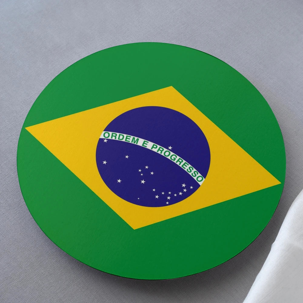 Round coaster with Brazilian flag design on a gray surface